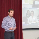 Man presenting in front of projected slide